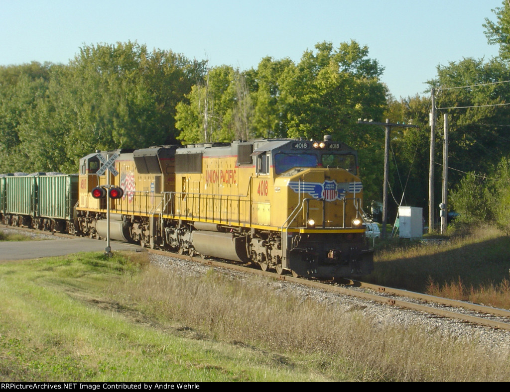 UP 4018 leads a loaded rock train across Door Creek Road